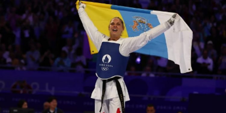 Una deportista celebra su medalla de oro para Hungría con la bandera canaria